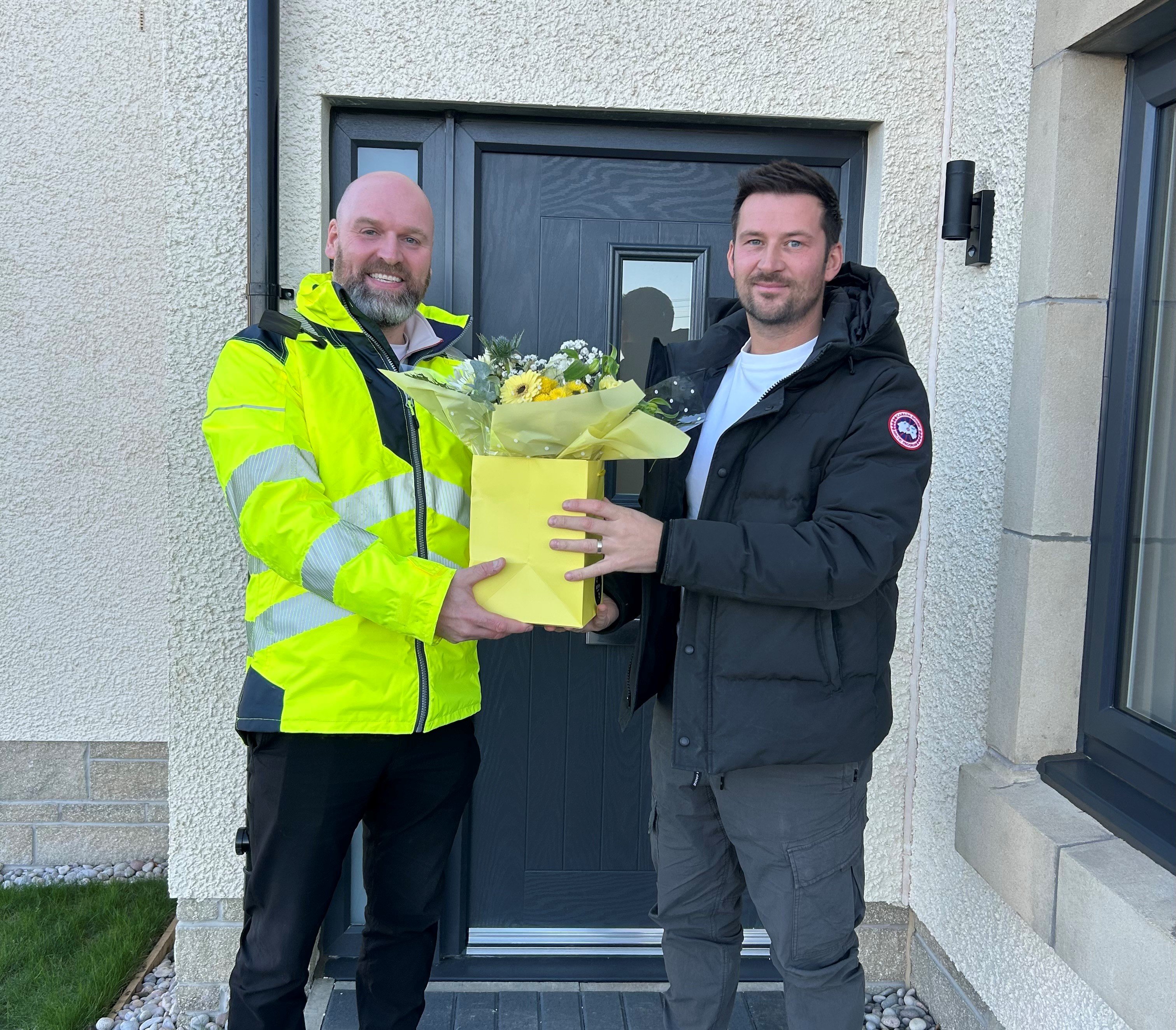 A warm welcome: Project Manager Gregor Ford, welcoming our very first customer to receive heat on our MEL heat network. Gregor‘s role is to ensure everything is running smoothly and is often on site to answer customer questions.